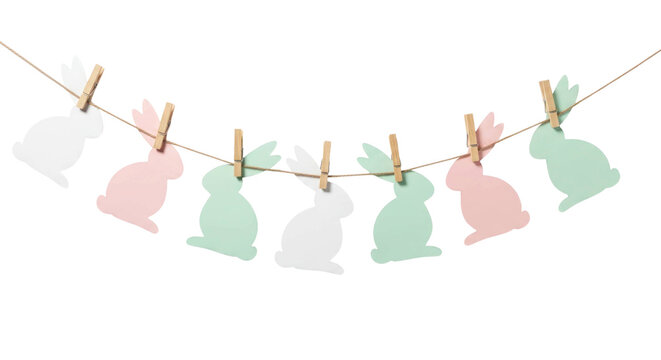 Colorful paper bunny decorations hanging on a string with wooden clips for festive celebrations or Easter-themed events. Isolated on transparent background.
