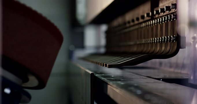 Close up of metal bending machine tool with industrial grinding wheel in factory workshop during manufacturing process