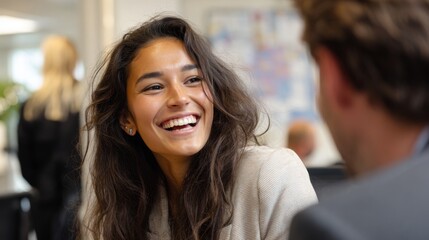 Obraz premium Multicultural Coworkers Sharing Laughter in a Modern Office Environment