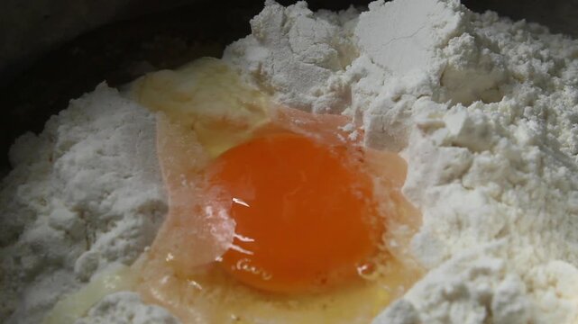 break an egg into the flour