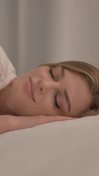 Side View of Young Woman Sleeping in Bed at Home, Vertical Video