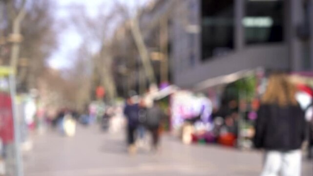 Barcelona, Spain - 10-02-2026: out of focus people walking in the Las Ramblas street in the city center during a spring sunny day