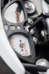 Motorcycle dashboard: speedometer and odometer in detail.