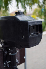 Outboard motor in the showroom: close-up of the hull and tiller.