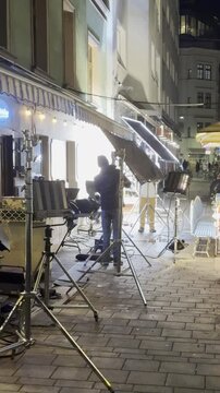 lighting crew on professional movie set at night in Vienna