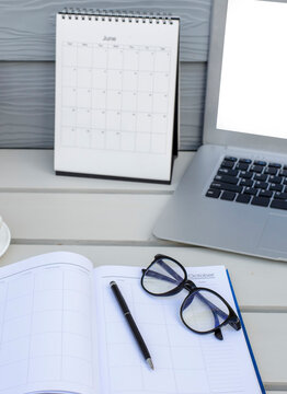 Calendar Planner book to plan reminder for daily appointment timetable, appointment, organization, and meeting agenda for job on wooden desk and working from home-banner image-vertical image.