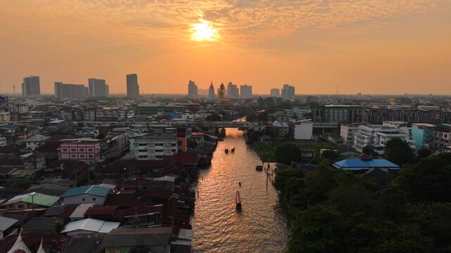 Aerial view Wat Paknam Bhasicharoen with wooden boat on river located in Phasi Charoen district, Bangkok, at the Chao Phraya River. It is part of the Maha Nikaya fraternity and is the origin of the Dh