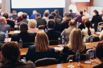 Conference, hall with audience, panel discussion at forum, people on a congress together listen to speaker on stage at convention, plenary session at business lecture seminar, venue for presentation