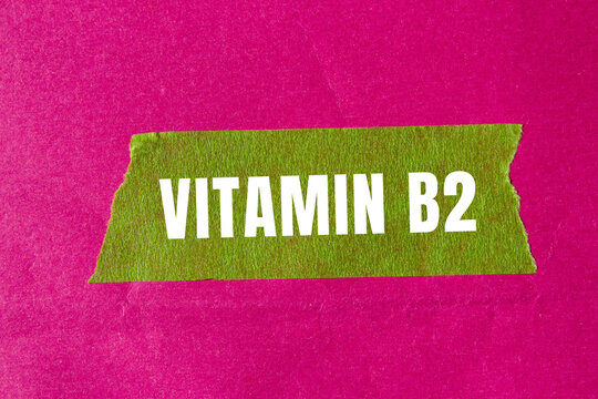 Vitamin B2 message written on ripped torn paper background. Conceptual Vitamin B2 symbol. Copy space.