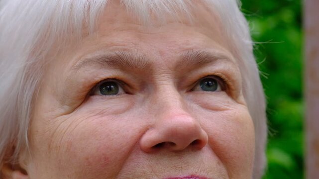 Close-up macro of the eyes of a senior woman. Depression. Intense look, sadness, anxiety, stress, waiting.