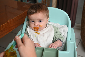 young child in a high chair to eat his meal