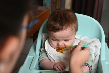 young child in a high chair to eat his meal
