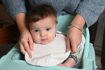 young child in a high chair to eat his meal