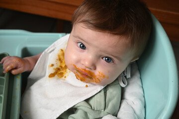 young child in a high chair to eat his meal