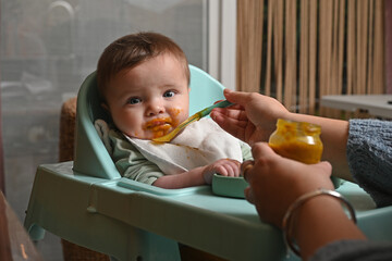 young child in a high chair to eat his meal