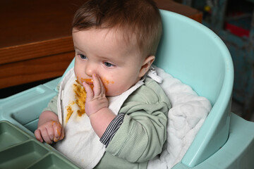 young child in a high chair to eat his meal