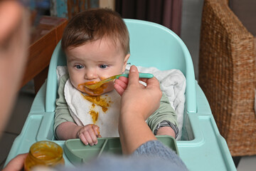 young child in a high chair to eat his meal