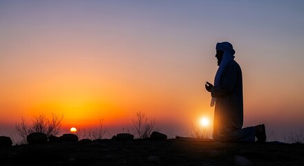 Fototapeta premium Silhouette of Man Standing at Sunset.