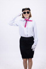 Flight attendant giving a salute in white uniform