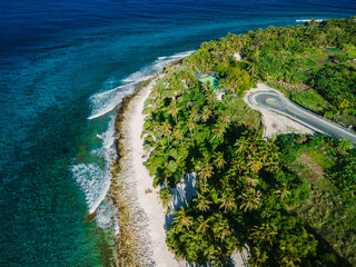 Maldives island ocean tropical beach with palms. Aerial view