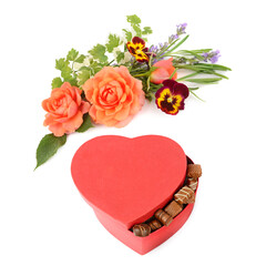 Red heart shaped box of chocolates with a beautiful summer flower bouquet