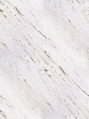 A close-up view of a light-colored, textured surface with diagonal lines and small imperfections. This appears to be a natural stone material, likely travertine or marble.