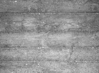 Obraz premium A seamless, repeating texture of weathered, grey concrete with a rough, grainy surface and visible wood grain patterns.