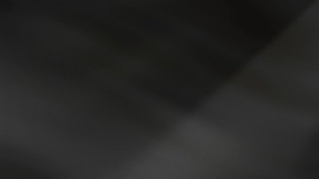 Abstract dark gray flowing fabric texture with subtle light reflections on transparent background