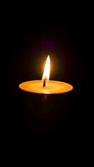 Fototapeta premium Burning Candle Flame in Dark Background Spiritual Concept