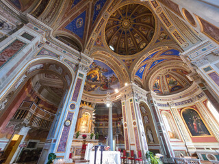 Obraz premium Interior view of the Madonna della Stella Sanctuary in Montefalco, Italy. A majestic Baroque church featuring a decorated dome, ornate golden altar, and religious frescoes on the ceiling
