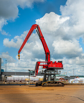 Halmstad, Sweden - July 18 2010: Massive red industrial crane at cargo dock.