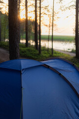 Serene Lake Scene At Sunset. Zoomedin View Of Tent Material With Calm Lake And Sunset Glow Behind