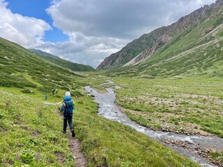 Fototapeta premium Group of hikers undertaking the multi-day Ak-Su Traverse in the spectacular Terim Tor Valley, Kyrgyzstan.