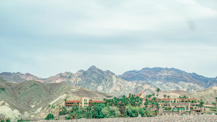A mountain range with a few houses in the distance