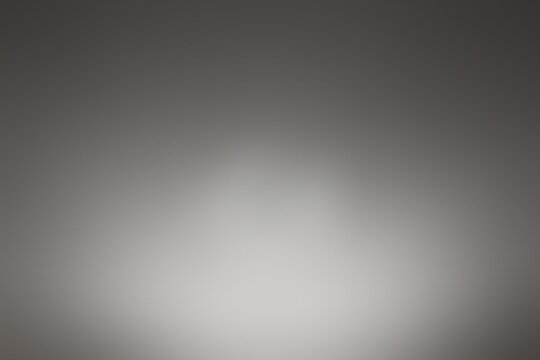 Gray defocused background with bokeh effect.