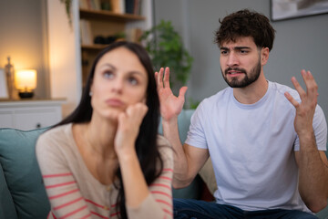 Fototapeta premium Young couple having argument and relationship conflict at home