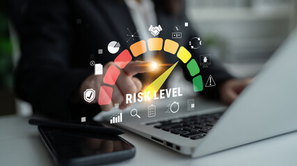 Business Professional Analyzing Risk Level with Digital Dashboard on Laptop in Modern Office...
