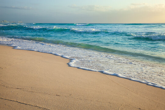 Low angle view of the beach and waves in Cancun Mexico on a beautiful morning