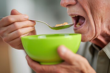Close-Up of a Senior Person Being Fed a Meal from a Green Bowl