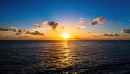 Obraz premium Serene Ocean Sunset with Golden Light and Cloud Formations.