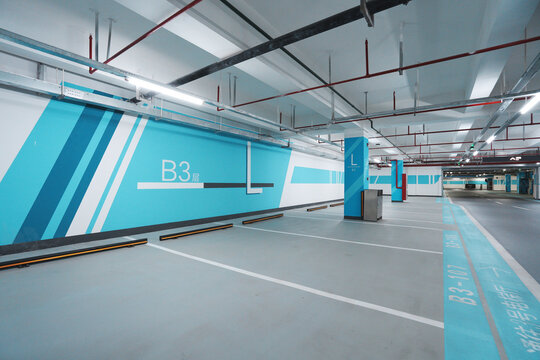 Underground parking garage level B3 with blue wayfinding signage system in clean modern interior