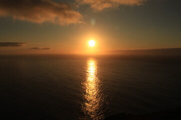 Sun reflecting on Atlantic waters at sunset from Farol de Ponta do Pargo Madeira