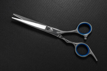 Close-up of hairdressing scissors on a black background