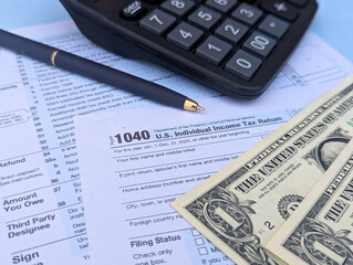 Fototapeta premium tax return form 1040 with calculator and money