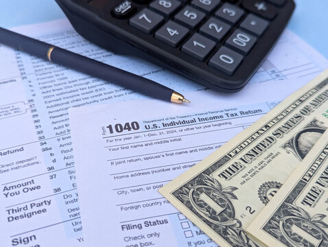 tax return form 1040 with calculator and money