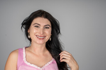 a woman smiling at the camera with her hair on the left side of her head 2