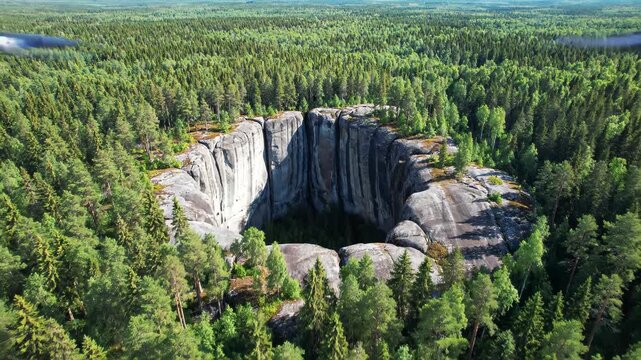 Aerial view of a deep rock chasm surrounded by dense forest