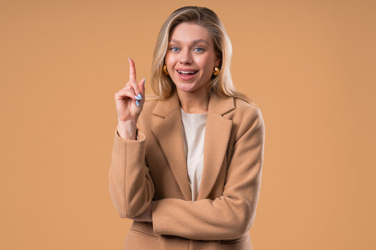 Breakthrough Genius Idea. Happy Blonde Businesswoman Eureka Moment, Pointing Finger Up