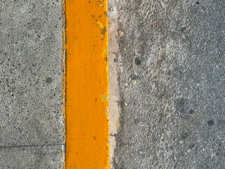 Fototapeta premium Yellow markings on dry asphalt close-up.