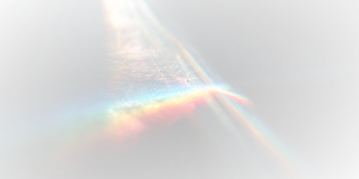 Blurred rainbow refraction drifts softly across black abstract surface. Prism colors shimmer in subtle streaks. Holographic overlay adds luminous dreamy glow.
